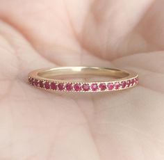 3/4 Eternity Band Ring with Pave Set Natural Ruby MaterialSolid Gold (14K & 18K) FinishHigh Polished/Shiny FitStandard Width1.5 mm Height1.5 mm EdgesMilgrain SettingPave StoneNatural Ruby QualityAAA Cut and ShapeDiamond Cut, Round Total Carat Weightapx 0.30 Click below to add laser engraving. https://www.etsy.com/listing/631070916/laser-engraving?ga_search_query=laser%2Bengraving&ref=shop_items_search_1&frs=1 This ring is full of elegance and beauty! It is so simple and so complete a Yellow Gold Halo Ruby Ring For Wedding, Wedding Ruby Eternity Band In Yellow Gold, Classic Ruby Eternity Band For Wedding, Wedding Yellow Gold Ruby Eternity Band, Yellow Gold Ruby Ring For Anniversary, Half Eternity, Yellow Gold Ruby Ring With Half Eternity For Anniversary, Yellow Gold Ruby Eternity Band, Anniversary Yellow Gold Ruby Ring With Half Eternity, Stackable Ruby Eternity Band For Weddings