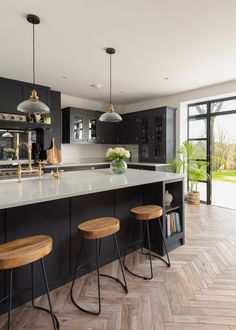 an instagram page with two stools in front of a kitchen island