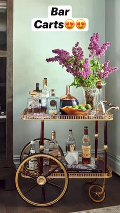 a bar cart filled with liquor bottles and flowers