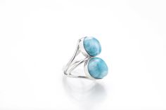 "Enjoy the new collection of double stone rings is now out and about! Check these state of the art creations from one of our greatest artisans. Two stones Larimar rings so creatively made and with so much love for you to enjoy and maybe, just maybe show off a little :) The marvelous blue Avaya Larimar ring reminds us of the beautiful and calm waters of our South beaches. Wear it and your hands will transport you to seas of tranquility. Make it yours! - Material: Larimar gemstone and 925 silver - Blue Larimar Round Rings, Elegant Blue Larimar Rings, Hallmarked Larimar Jewelry, Blue Sterling Silver Fusion Rings, Fusion Style Blue Sterling Silver Rings, Blue Fusion Style Round Rings, Elegant Round Larimar Jewelry, Calm Waters, Larimar Ring