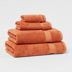 five orange towels stacked on top of each other