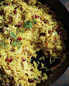 a pan filled with rice and beans on top of a table