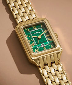 The rectangular Raquel watch is a new classic, updated for the current moment. Slim and versatile, this one-of-a-kind timepiece features a genuine malachite stone dial, three-hand date movement and a brushed and polished gold-tone 7-link bracelet.

Engravable watches. Embossable leather goods. Handpicked jewelry. It’s your destination for those “more than just a gift” gifts—just in time for Mother’s Day. Modern Green Watch With Rectangular Dial, Green Watches With Rectangular Dial And Analog Display, Green Formal Watch With Date Display, Formal Green Watch With Date Display, Elegant Green Rectangular Watch, Elegant Green Rectangular Watches, Timeless Green Watch With Analog Display, Elegant Green Watches With Rectangular Dial, Timeless Green Watch With Date Display