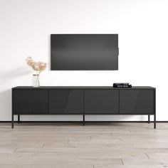 an entertainment center with a large flat screen tv mounted on it's sideboard