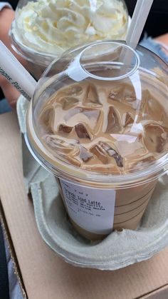 two cups of ice cream sitting on top of a cardboard box