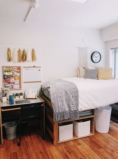 a bedroom with wood floors and white walls