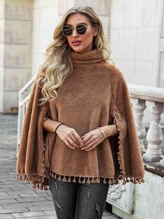 Full Size Turtleneck Tassel Hem Poncho – Body By J'ne Long Sleeve Fringe Poncho For Fall, Fringe Long Sleeve Poncho For Fall, Fringed Long Sleeve Poncho For Fall, Winter Cape With Tassels, Winter Fringe Cape Outerwear, Casual Winter Poncho With Tassels, Winter Long Sleeve Tops With Tassels, One Size Cape Top For Winter, Trendy Fringe