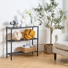 a living room with a couch, chair and two shelving units on the floor