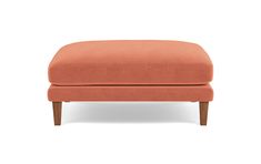 an orange ottoman with wooden legs on a white background