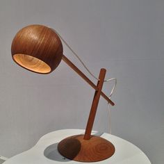 a wooden lamp sitting on top of a white table