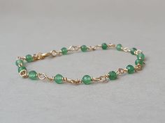 A beautiful bracelet with soothing light green genuine aventurine Please measure tightly your wrist's circumference, using a thread or something similar, and then measuring the thread with a ruler. When ordering, please select the actual wrist size, not the size of the bracelet. I will make the bracelet fit your wrist, by adding approx 0.6 inch to the circumference. The bracelet was set up using genuine aventurine faceted rondeles and gold filled findings and it is adjustable. Available also in sterling silver finish.  Aventurine is an excellent prosperity talisman, it channels abundance and brings good luck in money. Place this stone in the north corner of a room to stimulate abundance and in the west for relationships. Aventurine is a very positive stone of prosperity.  Wearing Aventurin Adjustable Gold Aventurine Beaded Bracelets, Green Aventurine Beaded Bracelets, Hand-strung Aventurine Bracelet, Green Polished Aventurine Beads Jewelry, Adjustable Hand-strung Aventurine Beaded Bracelets, Green Aventurine Bracelet, Aventurine Bracelet, Aventurine Jewelry, Gold And Green