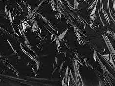 black and white photograph of plastic wrapper textured with metallic foil on the surface