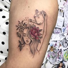 a woman's arm with a flower tattoo on it