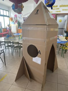 a cardboard box shaped like a rocket ship with a hole in the front and door