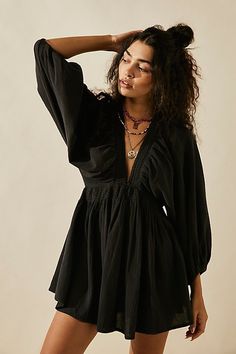 The definition of romantic, this mini from our free-est collection will turn heads with every wear. **Fit:** Relaxed, A-line silhouette **Features:** Plunge V-neckline, billowy banded sleeves, smocked waist, back keyhole button closure **Why We | For The Moment Mini Dress by free-est at Free People in Black, Size: XS Dirndl Outfit, V Neck Tunic, Bandeau Tops, Flowy Mini Dress, Beach Skirt, Mini Robes, Party Dress Short, Puff Sleeve Dresses, Smocked Dress