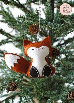 an ornament hanging from a tree with a fox on it's head