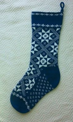 a pair of blue socks with white and black designs on them hanging from a hook