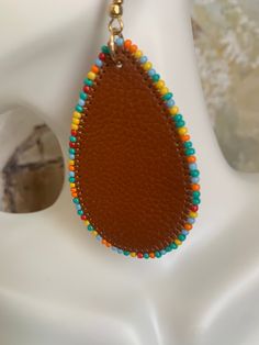 Leather Beaded Western Themed Earrings. Fun and beautiful western themed Earrings with colorful beautiful beads and leather Brown Jewelry With Colorful Beads, Brown Beaded Teardrop Jewelry, Handmade Brown Teardrop Beaded Earrings, Multicolor Beaded Leather Jewelry, Brown Round Bead Earrings For Festivals, Brown Beaded Dangling Earrings For Festival, Brown Dangling Beaded Earrings For Festivals, Southwestern Brown Beaded Earrings As Gift, Southwestern Style Brown Beaded Earrings Gift