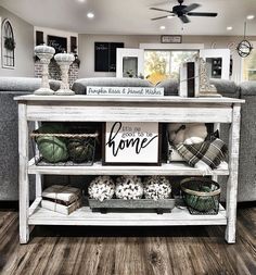 a living room filled with lots of furniture and decor on top of a wooden floor