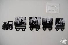 a black and white photo of children's pictures hanging on the wall next to a light switch