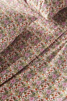 a close up view of a flowered shirt with pink and green flowers on it