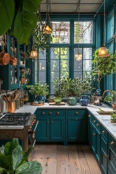 a kitchen filled with lots of green plants next to a stove top oven and sink