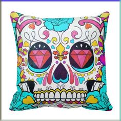 a pillow with a colorful skull design on the front and side of it's face