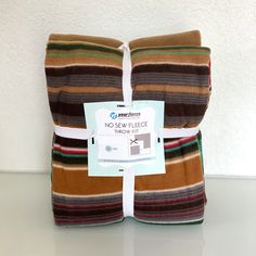 two brown and green striped towels sitting on top of each other