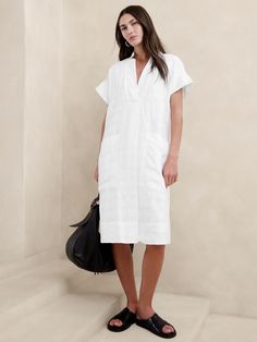 Effortlessly at-ease, we cut this shift dress from a beautiful blend of certified European linen and cotton—one we love for its lived-in look and ability to stay cool and crisp, even in heat and humidity.  Relaxed fit.  V-neck.  Pull-on design.  Side pockets.  Fully lined.  Relaxed fit.  Short sleeves.  Knee length.  Model: Size S, 5'10" (178cm). Utility Dress, Short Sleeve Midi Dress, Midi Short Sleeve Dress, Casual Stylish, Linen Shop, Sleeve Midi Dress, Cotton Style, Look Cool, Shift Dress