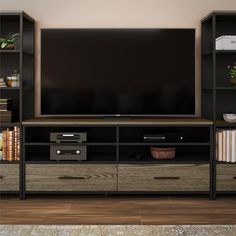 a flat screen tv sitting on top of a wooden entertainment center