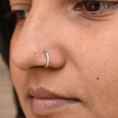 a close up of a person with a nose ring