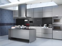 a modern kitchen with stainless steel appliances and counter tops