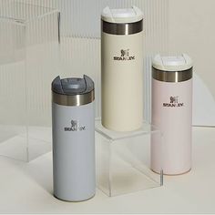 three different types of travel mugs on display