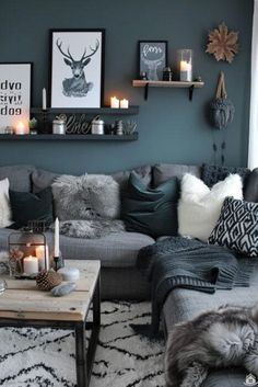 a living room filled with lots of furniture and candles on top of the coffee table