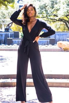 Introducing the Black Long Sleeve Jumpsuit which is an effortless choice to look incredibly stylish and chic! This jumpsuit features a deep v neckline, long sleeves and elastic cuffs. It's truly a classy item that you will love wearing over and over again. This jumpsuit is sleek and elegant with wide pant legs and a surplice bodice to shape your silhouette. This jumpsuit has a high elastic waist (with a tying sash belt). For a stunning look, you can belt it with Bella Chic Fashion Boutiques' bla Formal Fall V-neck Jumpsuits And Rompers, Sleek V-neck Jumpsuits And Rompers For Work, Elegant V-neck Jumpsuits And Rompers For Going Out, Elegant V-neck Jumpsuit For Date Night, Sleek Evening Jumpsuits And Rompers For Fall, Sleek Formal Jumpsuits And Rompers With V-neck, Sleek Formal V-neck Jumpsuits And Rompers, Sleek Black Long Sleeve Jumpsuits And Rompers, Black Long Sleeve Jumpsuit For Night Out