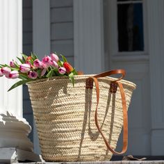 Look chic and smart while you stroll the farmer's market with your classic French tote basket. Switch between two sets of leather handles, long shoulder straps for when you want your hands free and short tote handles when you want to hand-carry your basket. This basket is ready for adventure! Use it as a beach bag, a pool tote, or a spacious picnic basket. When you're home, it makes for an attractive storage option hanging up or in a corner. Keep your basket in your car or display it on a hook n Classic Summer Bags With Leather Handles, Classic Bags With Leather Handles For Summer, Shopping Straw Tote Bag With Handle Drop, Spring Travel Straw Bag With Rolled Handles, Classic Summer Bags, Classic Straw Bag With Leather Handles For Travel, Straw Bag For Daily Use In Summer, Classic Straw Tote Bag For Everyday Use, Classic Natural Straw Tote Bag