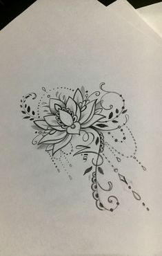 a drawing of a flower on top of some white paper with black and grey ink