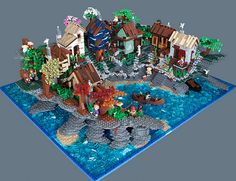 a lego model of an island with houses and boats