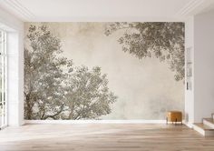 an empty room with a tree mural on the wall