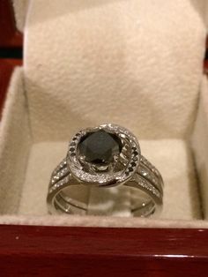 an engagement ring in a wooden box