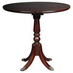 a round wooden table with two legs