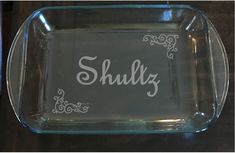 a glass dish with the word sully written in white ink on it, sitting on a table