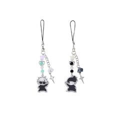 two earrings with charms attached to them on a white background, one has a black cat and the other is a bear