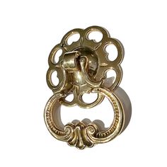 an ornate gold door handle on a white background