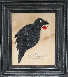 a black bird with a flower in it's beak