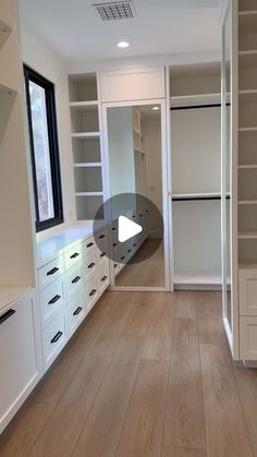 an empty walk in closet with white cabinets and drawers