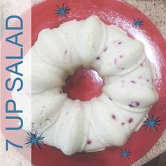 a red plate topped with a bundt cake covered in icing