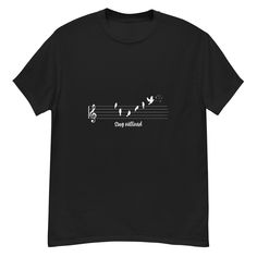 a black t - shirt with music notes and birds on the treble, printed in white