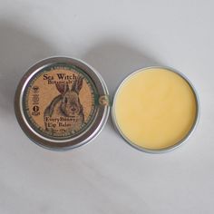 Made with Fair Trade Ingredients Plastic-Free Packaging Certified Vegan It's the Balm with the Bunny! Vegan Lip Balm Tins Our cruelty-free, animal-free lip balms come in a plastic-free sustainable tin, featuring candelilla wax in place of beeswax, providing a silky smooth application that is 100% plant-derived! This naturally scented lip balm features fair trade organic cocoa butter and fair trade organic coconut oil, giving your lips the delight of a coconut chocolate bar, without the calories. Coconut Chocolate Bars, Lip Balm Tin, Scented Lip Balm, Coconut Chocolate, Homemade Lip Balm, Vegan Lip Balm, Chocolate Coconut, Lip Balms, Lip Care