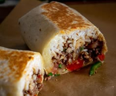 a burrito cut in half sitting on top of a table